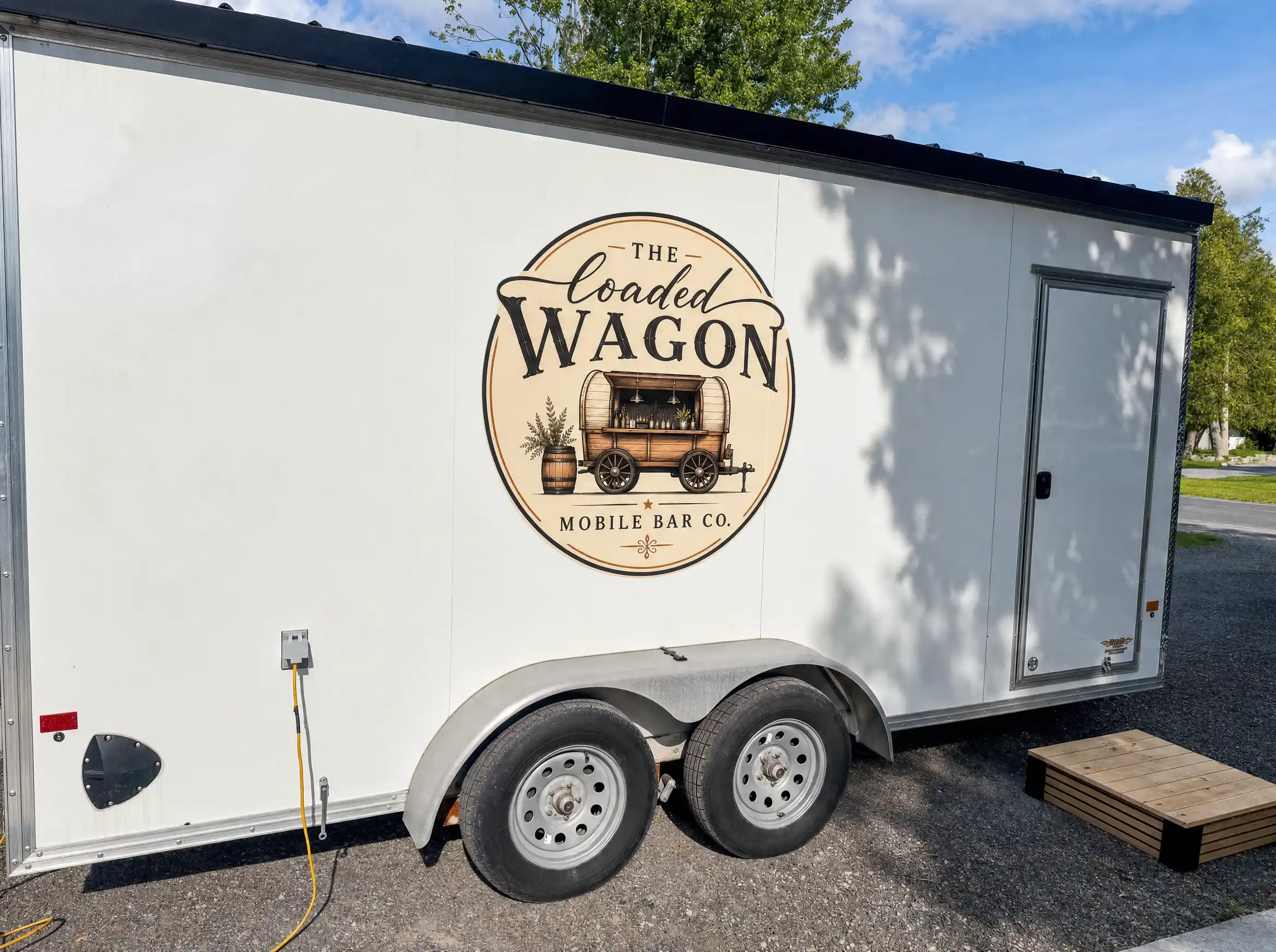 The side of the trailer showing the painted The Loaded Wagon Mobile Bar Co. logo.